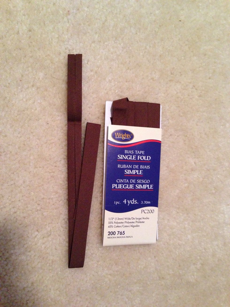 Use bias tape or create your own matching strap used for hanging. I cut mine about 15".