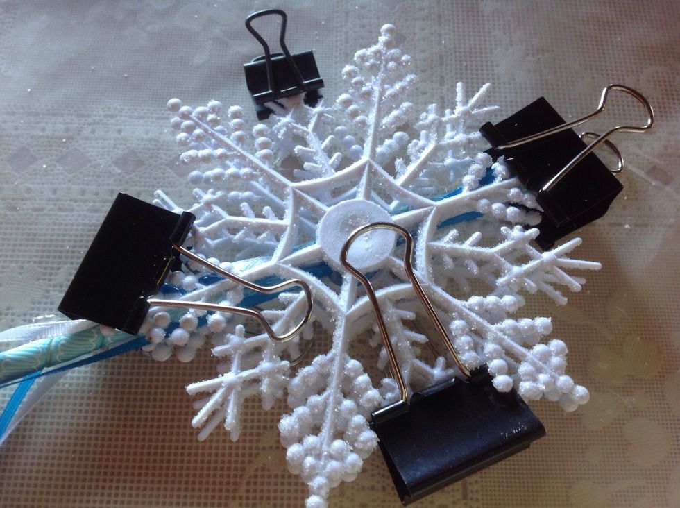 Use binder clips to hold snowflakes together. Give this a few hours to completely dry.