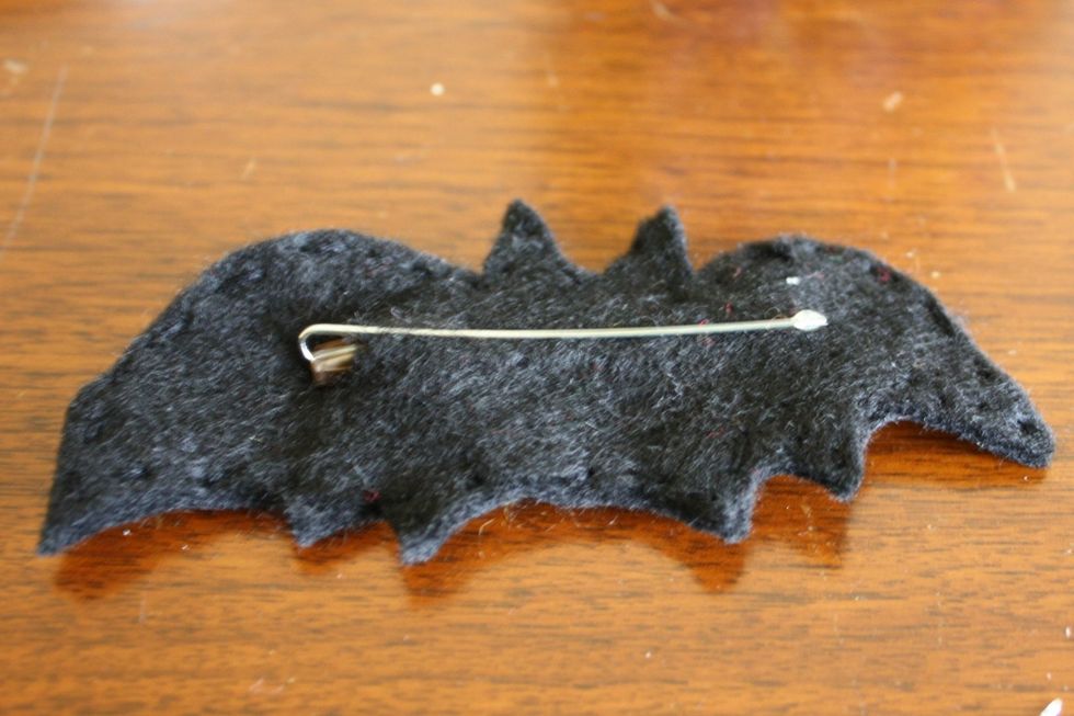Use black embroidery thread to sew around the edges of the two bats so that they are sewn together. Cut a small slit {about 1/4 inch} in the back of the bat and insert the bobby pin. That's it!