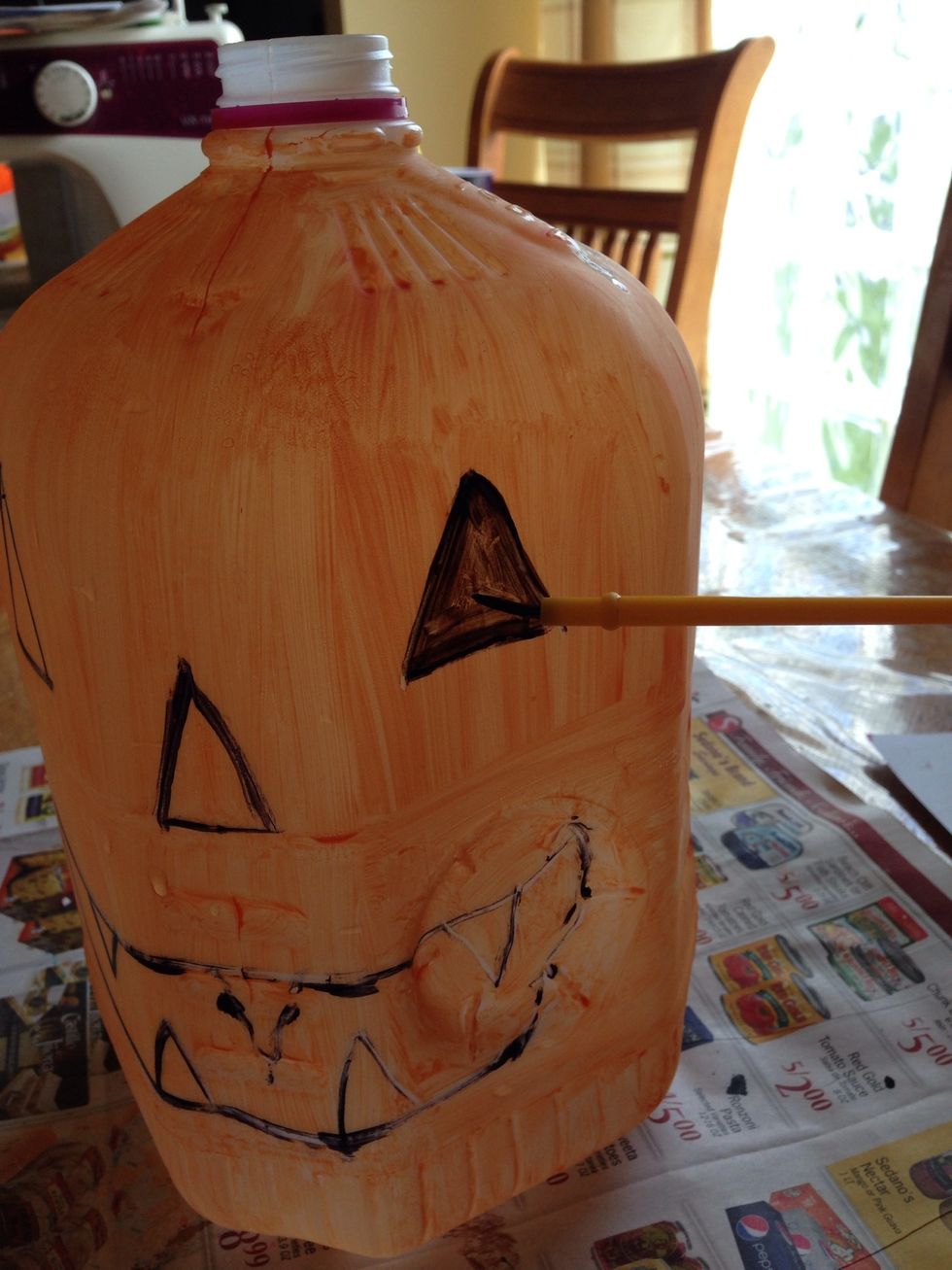 Use black paint to color in the features.