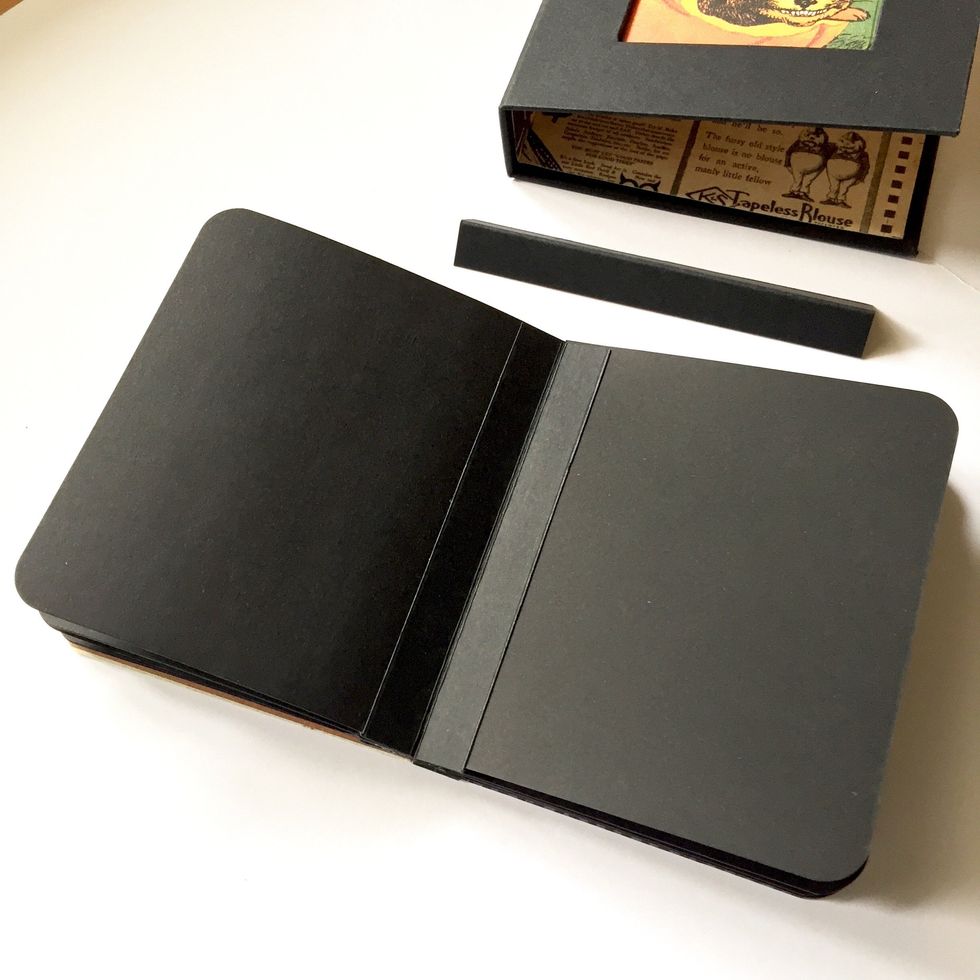 Use black tags contained in Graphic 45 Black Mix Media Box set to make album pages, gluing one each other with a strip of black cardstock.