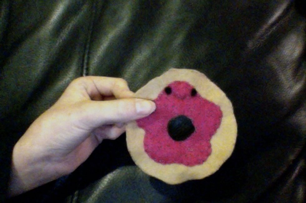 Use black thread to stitch on a smile.