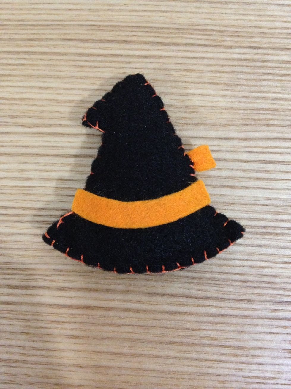 Use blanket stitches to sew up after filling up with poly stuffing! Don't forget to use simple stitch to attach the tiny orange strap onto the hat!