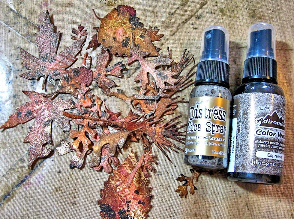 Use blending tool to ink the edges of the die cut leaves with Gathered Twigs.Spritz lightly with Tarnished Brass Mica Spray.  Spatter with Espresso Color Wash Spray.