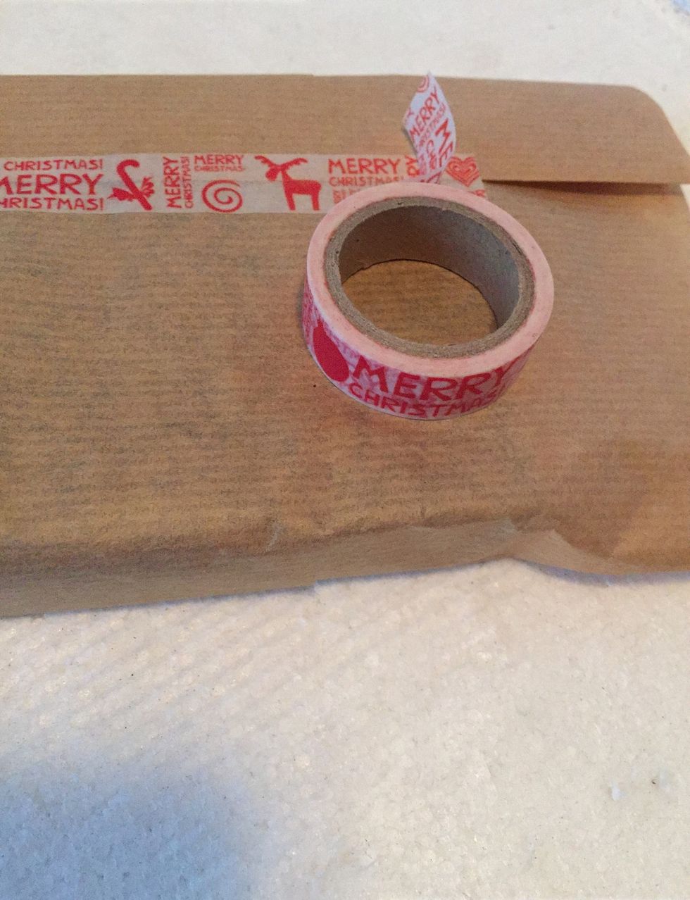 Use brown paper to wrap present using washi tape. Wrap with ribbon tie a bow and stick on a flower