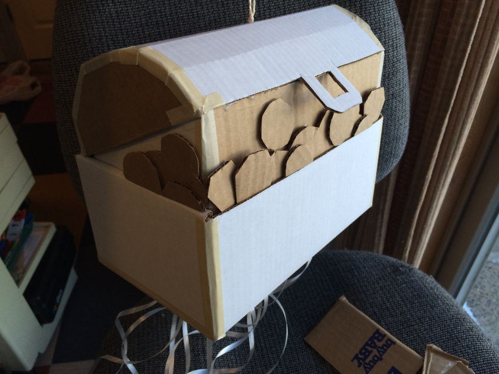 Use cardboard, glue & tape to make the box. I used a box with a "hinged" lid and added bends to the lid to look curved. I put flat pieces inside to make the lid look open yet still close off the box.