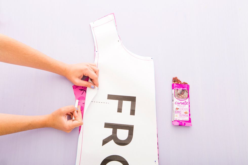 Use chalk to transfer the dotted line marking seen on the front pattern of the dress onto the fabric.