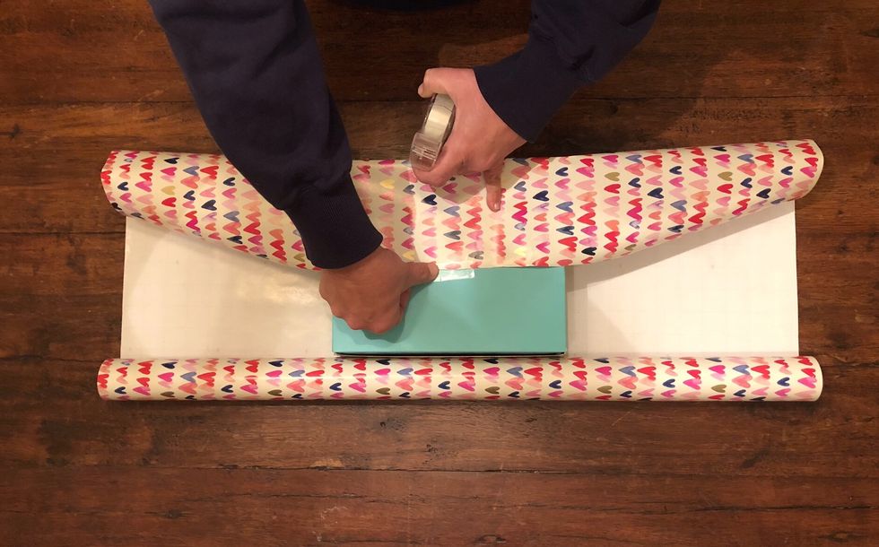 Use clear wrapping tape to secure the paper to the present.