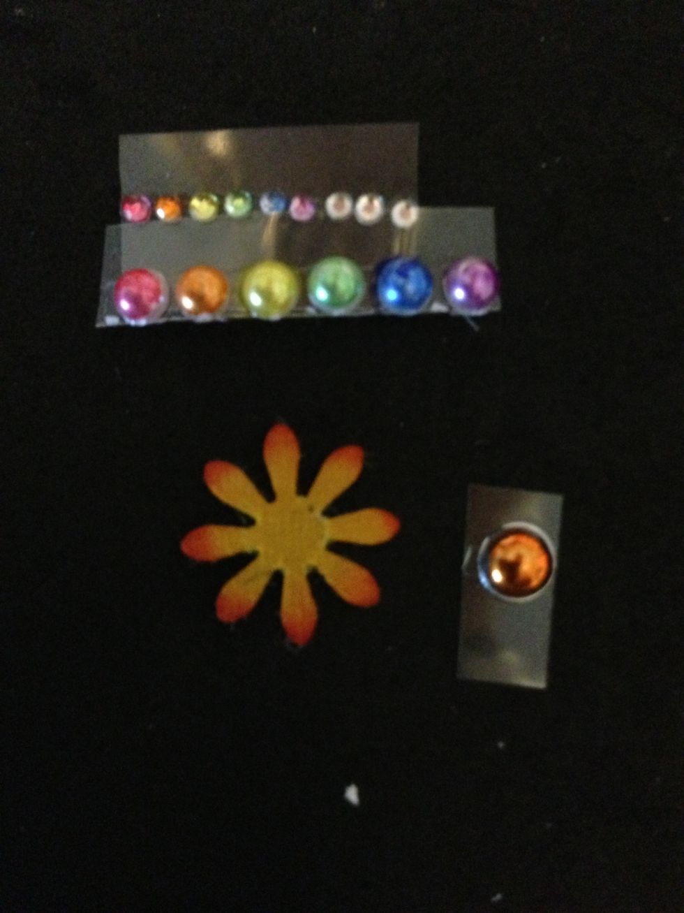 Use Copic markers to color 6 rhinestones, 6 pearls, brad and flower.