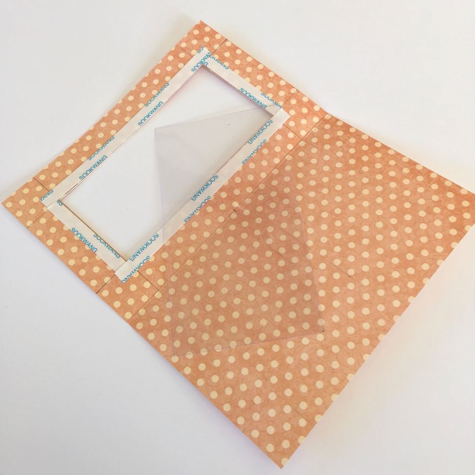 Use double sided tape to adhere a piece of acetate on the window.