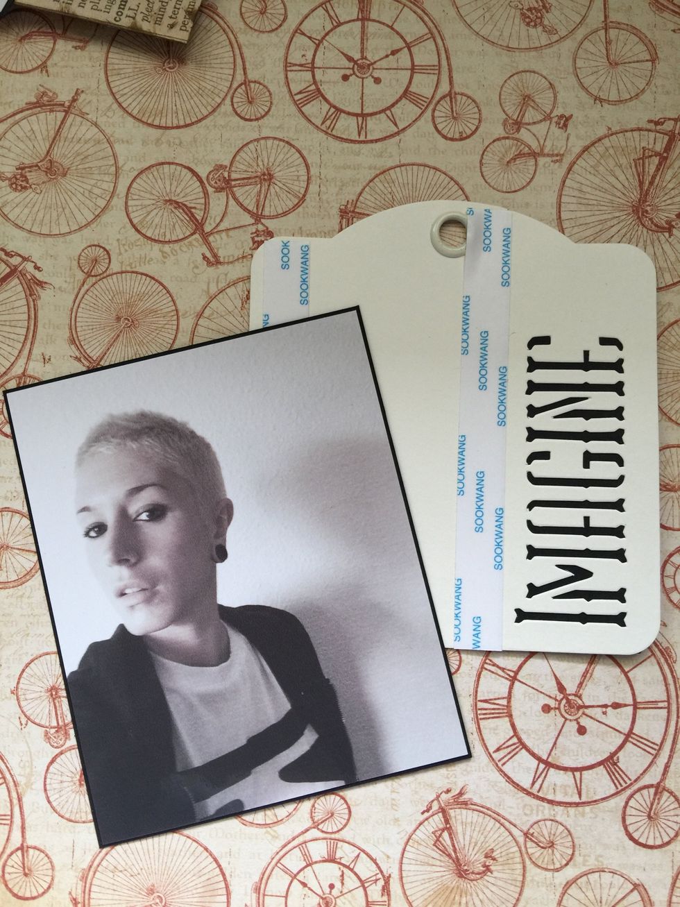 Use double-sided tape to stick another photo on the "Imagine" ivory tag.