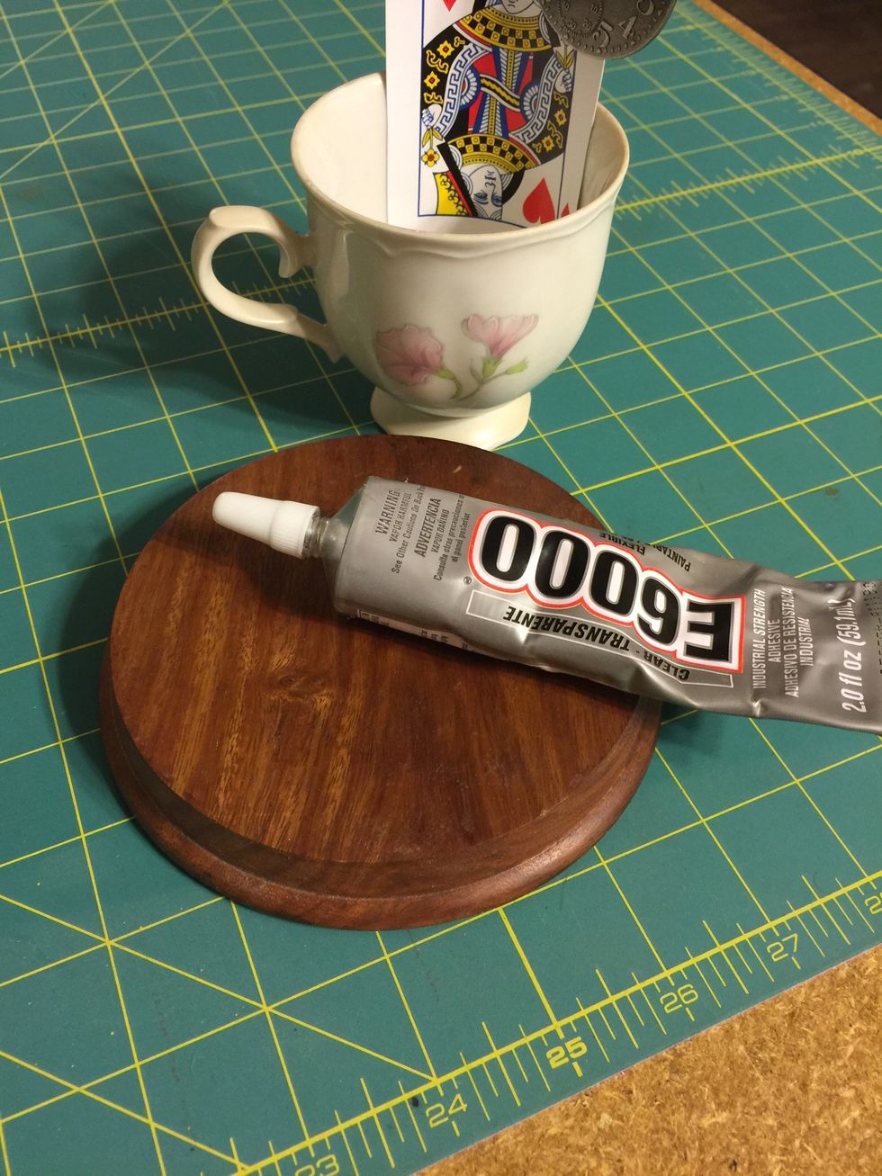 Use E6000 adhesive on the bottom of your teacup to bond to the base of your choice.