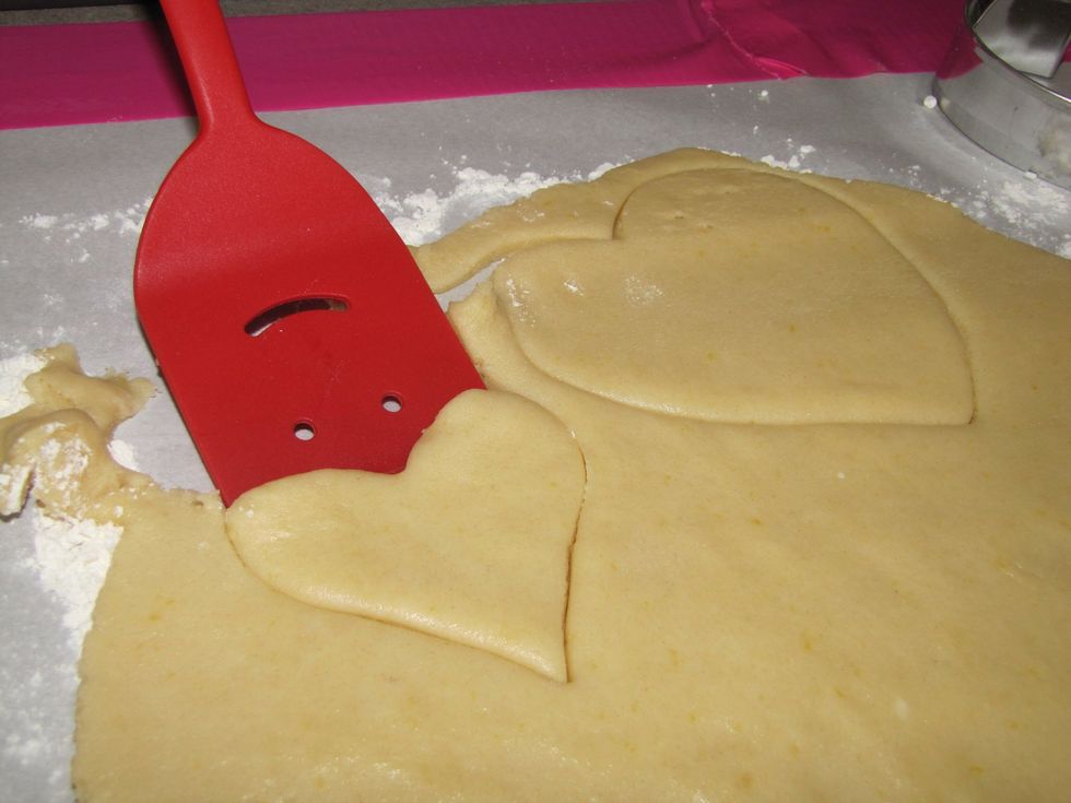 Use either a spatula or your fingers (whichever is easier) to remove the cookie shape from the flattened dough.