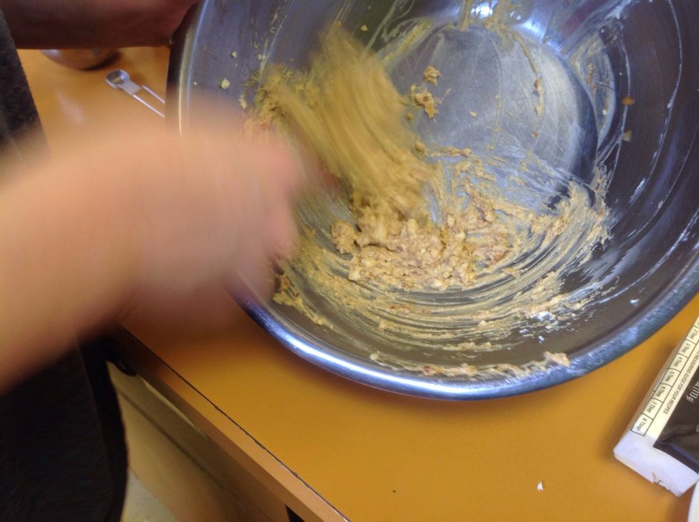 Use either the rubber scrapper or the whisk to mix the cheese mixture until it is smooth. This will take some time and arm muscles!