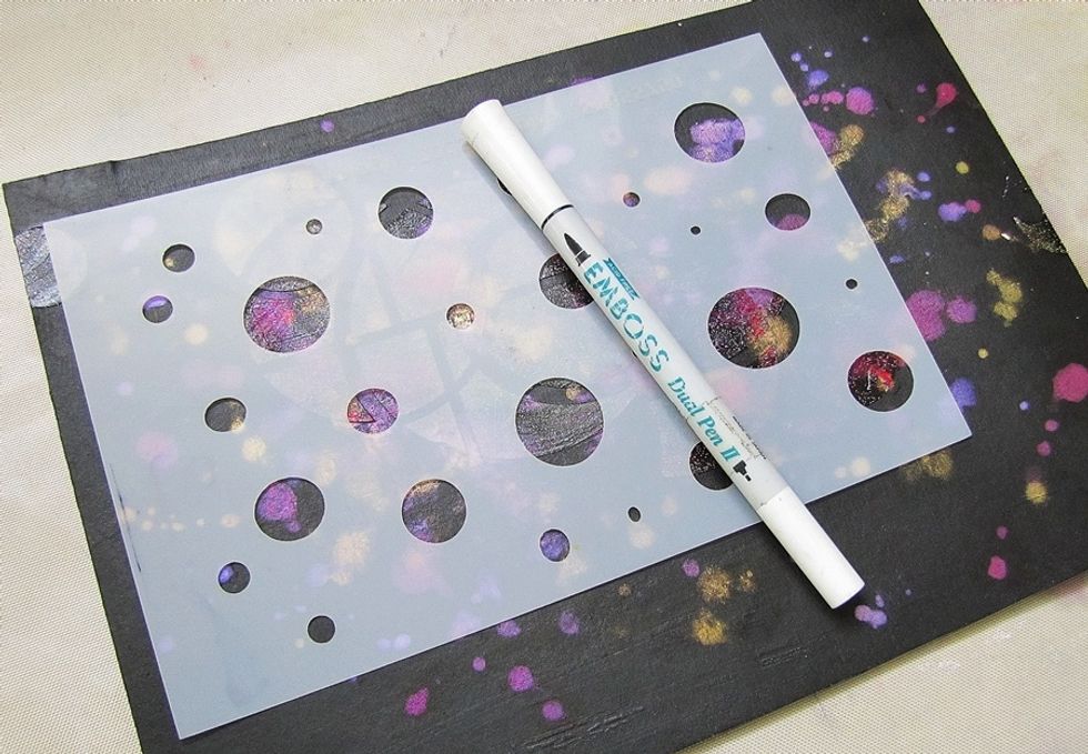 Use embossing pen with the stencil, create some circles.