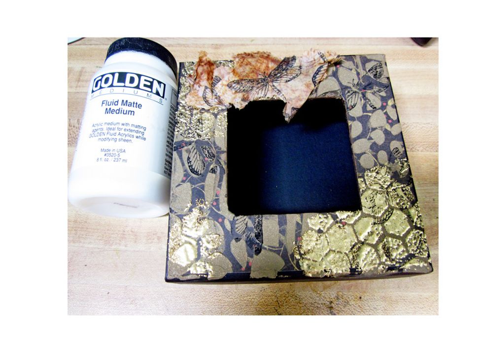 Use Fluid Matte Medium and tear pieces of the stamped tissue paper randomly over the top of the box. You could also use Modge Podge if you didn't ahve any of the Fluide Medium.