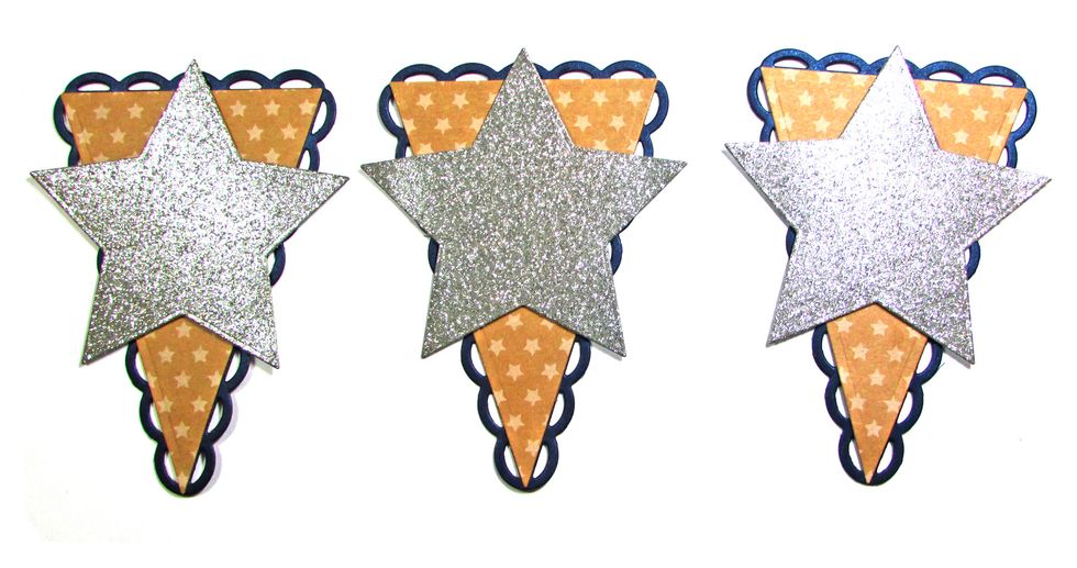 Use foam adhesive to attach a silver star to each pennant.