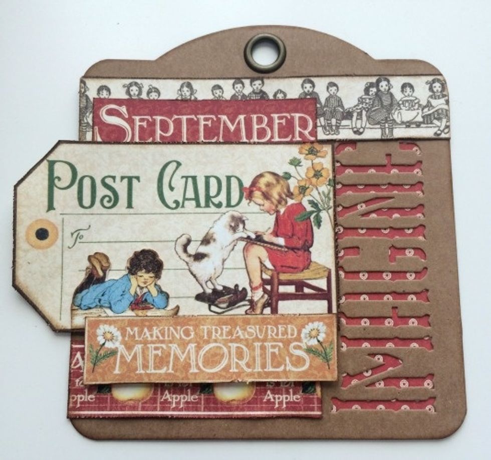 Use foam squares to adhere the making memories over top on the right hand side of the post card. The sentiment will cover parts of the apple border.