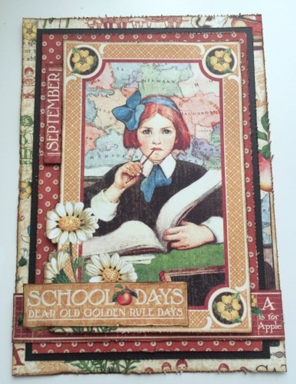 Use foam squares to adhere the School Days sentiment slightly over top of the daisies in the bottom left hand corner.