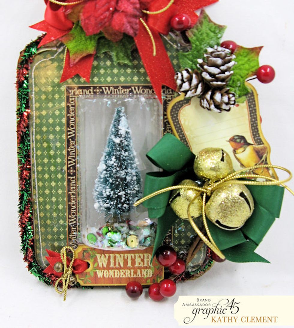 Use foam tape to secure the Winter Wonderland Chipboard Tag to the base of the packaging. Now the tag is finished and ready to hang on the tree, display in your home or add to a gift package.