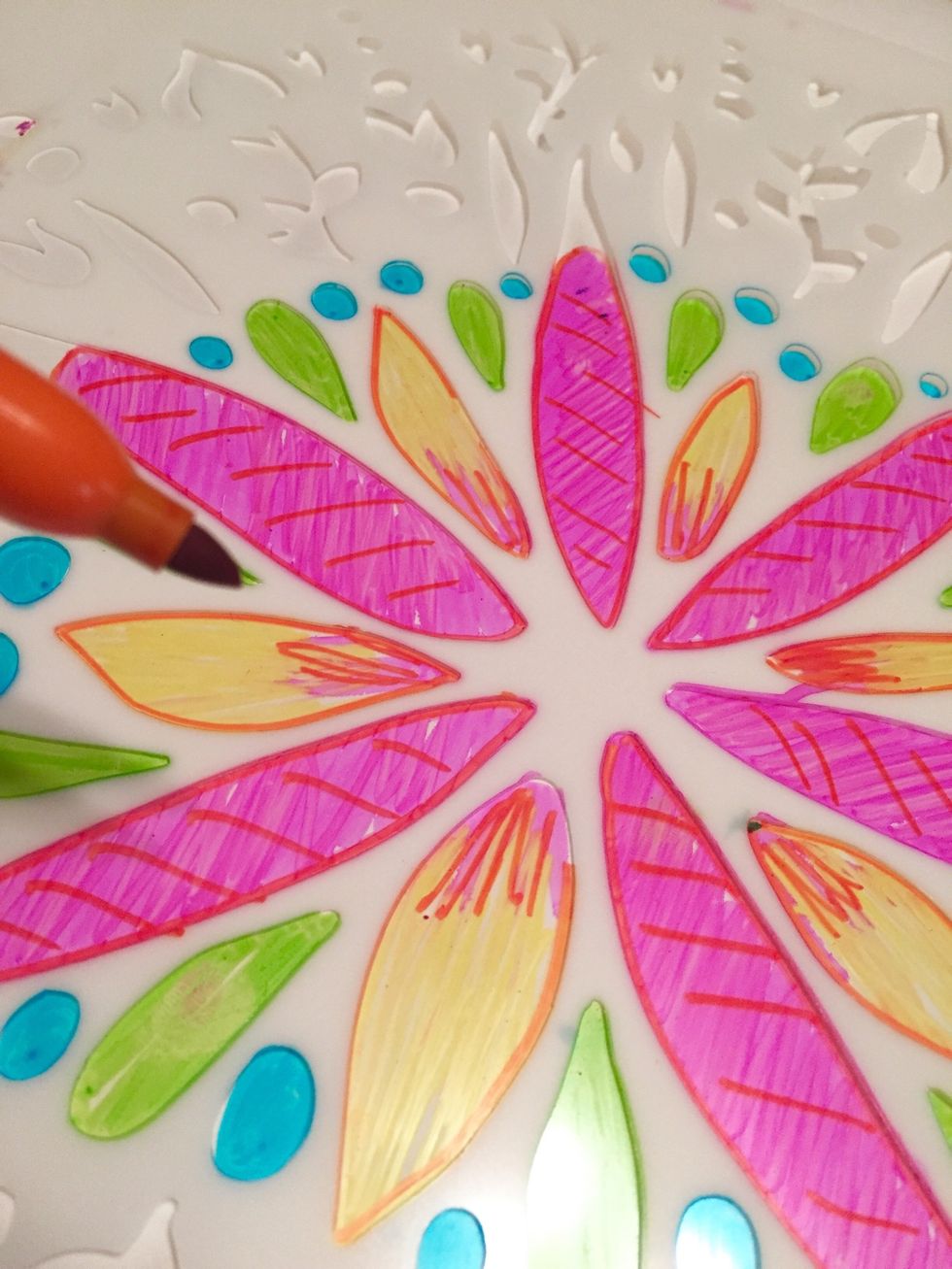 use Folk Art Flower Stencil and all colors of Sharpies to make design on another sheet of Shrink Film to use as the top of the mobile.