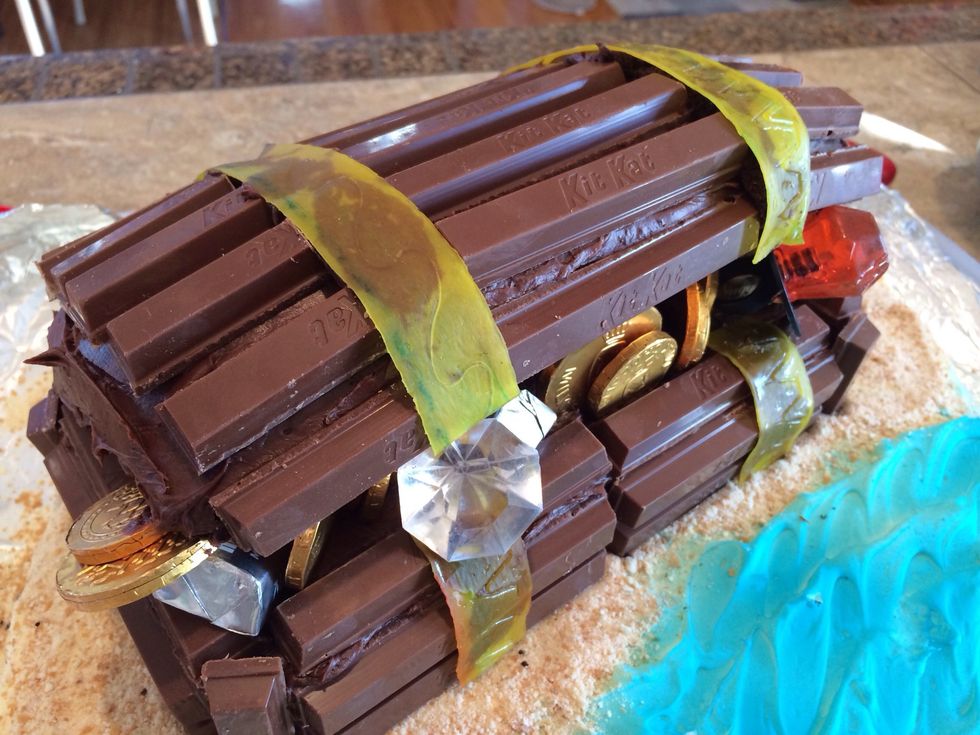 Use frosting to stick on Fruit by the Foot bands. I'm thinking in hindsight, a lighter frosting would have looked better and not shown through as much.