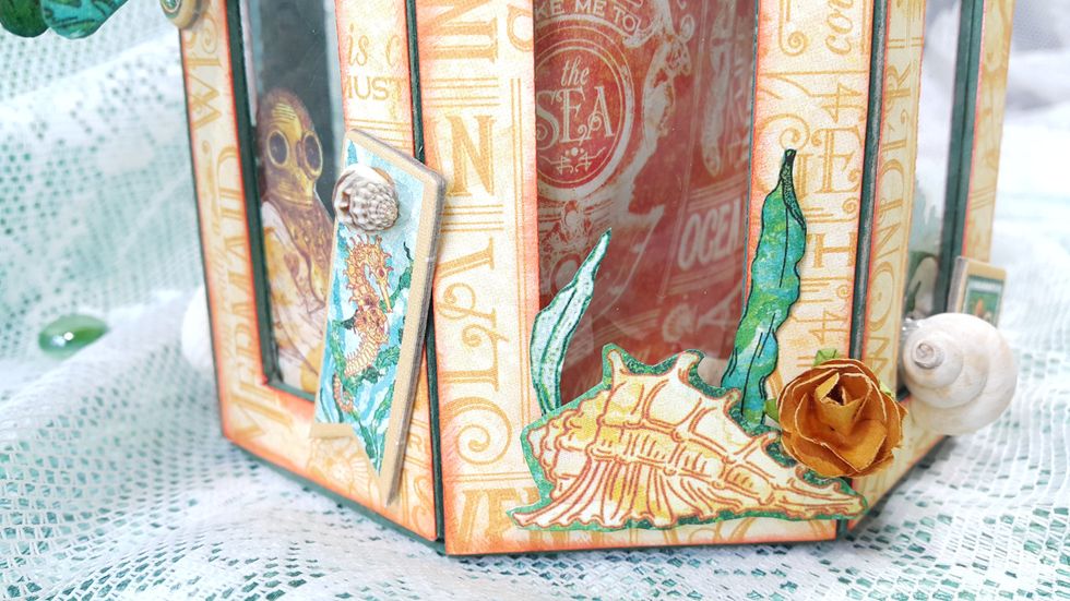 Use fussy cuttings to form the layers outside the teapot, mixing with paper flowers and chipboard.