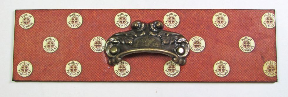 Use G45 Communique paper to cover the drawer "false front." Attach a G45 Antique Metal Door Pull to the center of the panel.