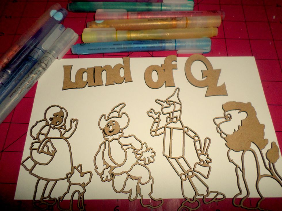 Use glitter markers (or any glitter product) to color your chipboard shapes.  Let dry.