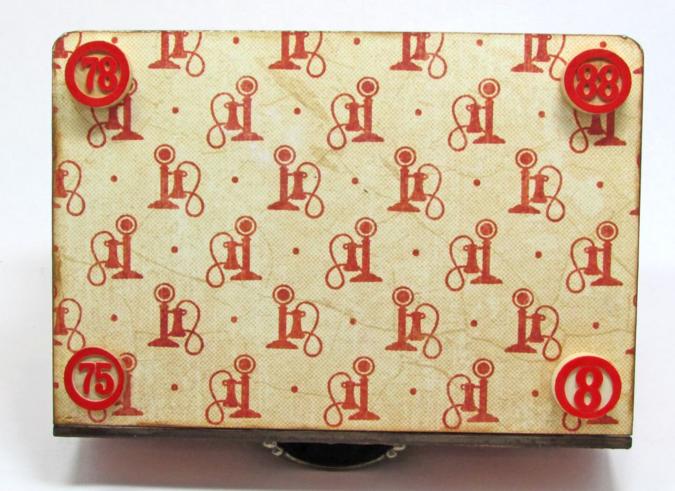 Use Glossy Accents to glue the bingo tiles to the bottom of the book box. Glue one tile to each corner as shown.