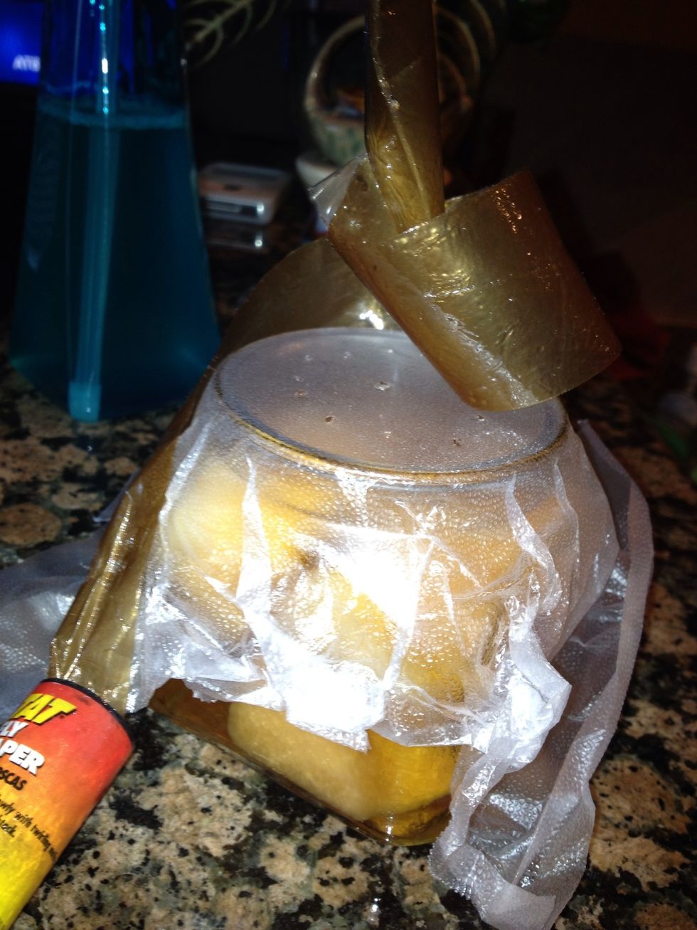 USE GLOVES. Unroll then wrap 1 spool of the sticky fly tape around the jar as an extra trap. Sometimes the flies will hang outside the jar. With the tape, they'll get stuck.