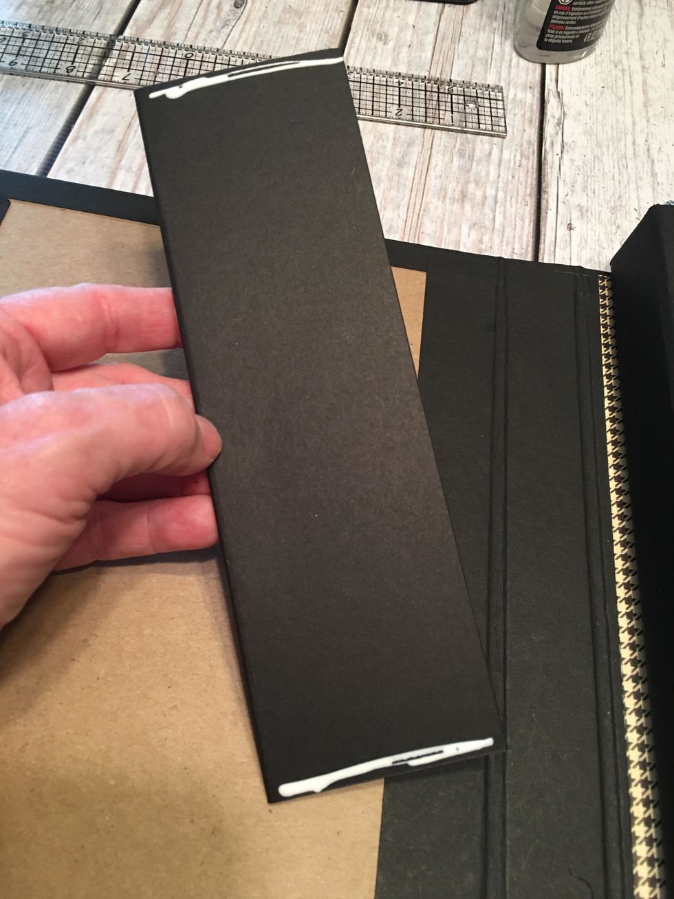 Use glue or scor-tape to attach the flap to the top edge of the first 8 1/2" section of the album.  See next photo before attaching.