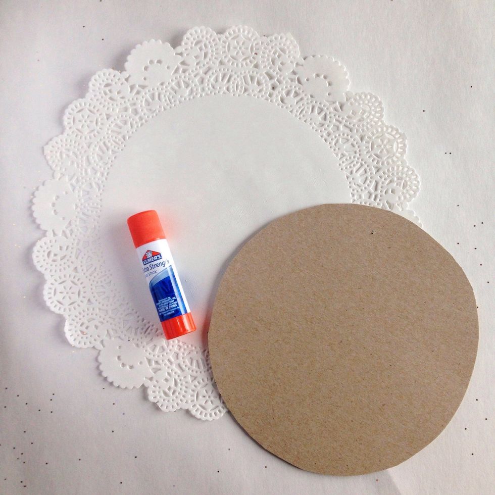 Use glue stick to glue the cardboard to the back side of the doily.