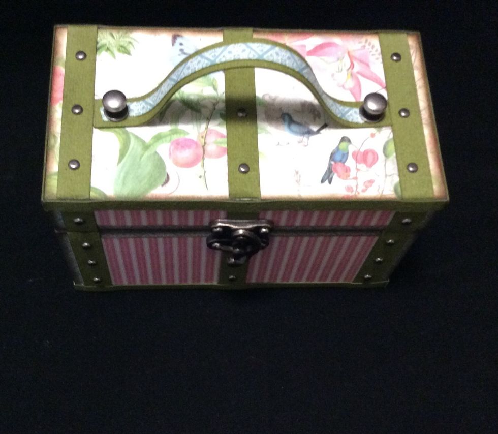 Use grunge paper strip to make handle. Cut length to 6 inches. Cover the reverse side with paper. Mat other side leave a border. Attach handle with scor tape to position. secure with brads or similar
