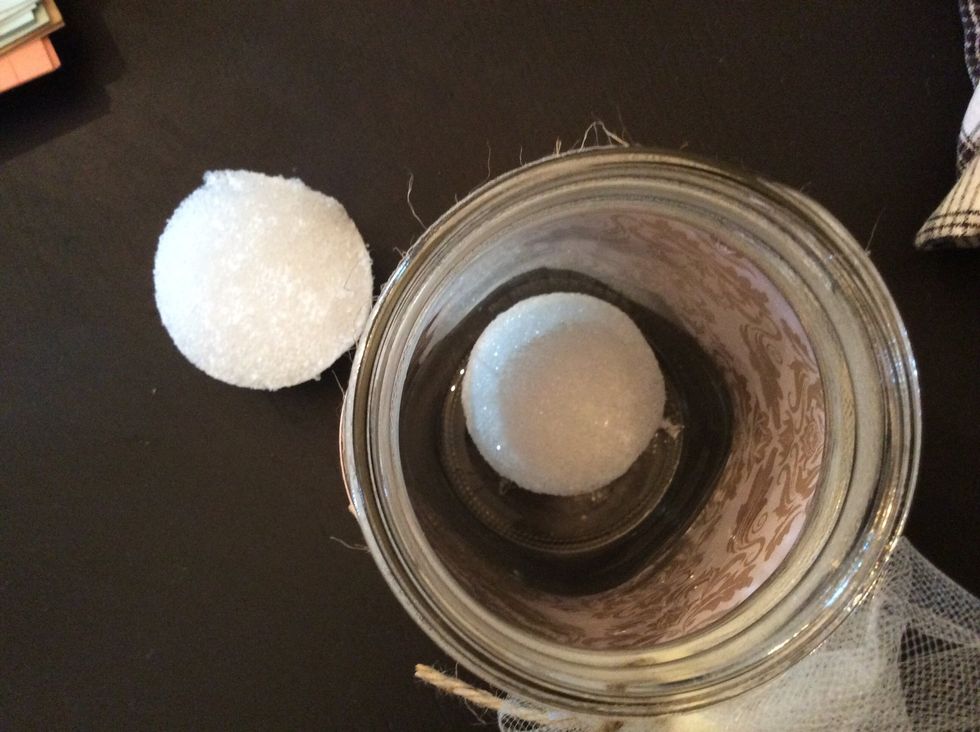 Use hot glue to secure half ball (flat side down) into bottom of jar. Do this with both ball halves, creating 2 anchor jars for banner.