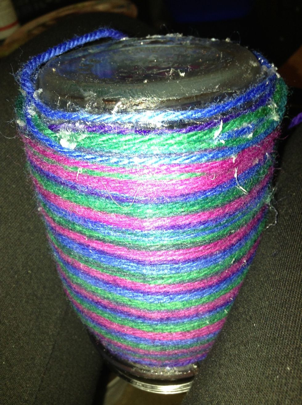 Use hot glue to secure the yarn to the jar.