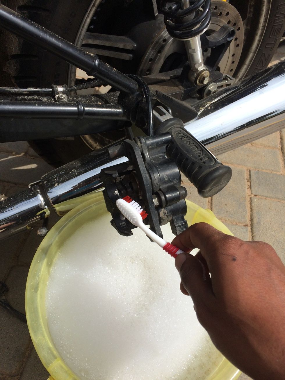 Use hot soap water and clean the caliper