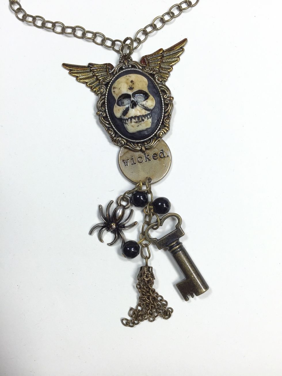 Use jump rings and a short piece of necklace chain to attach several charms and other bits that you desire.