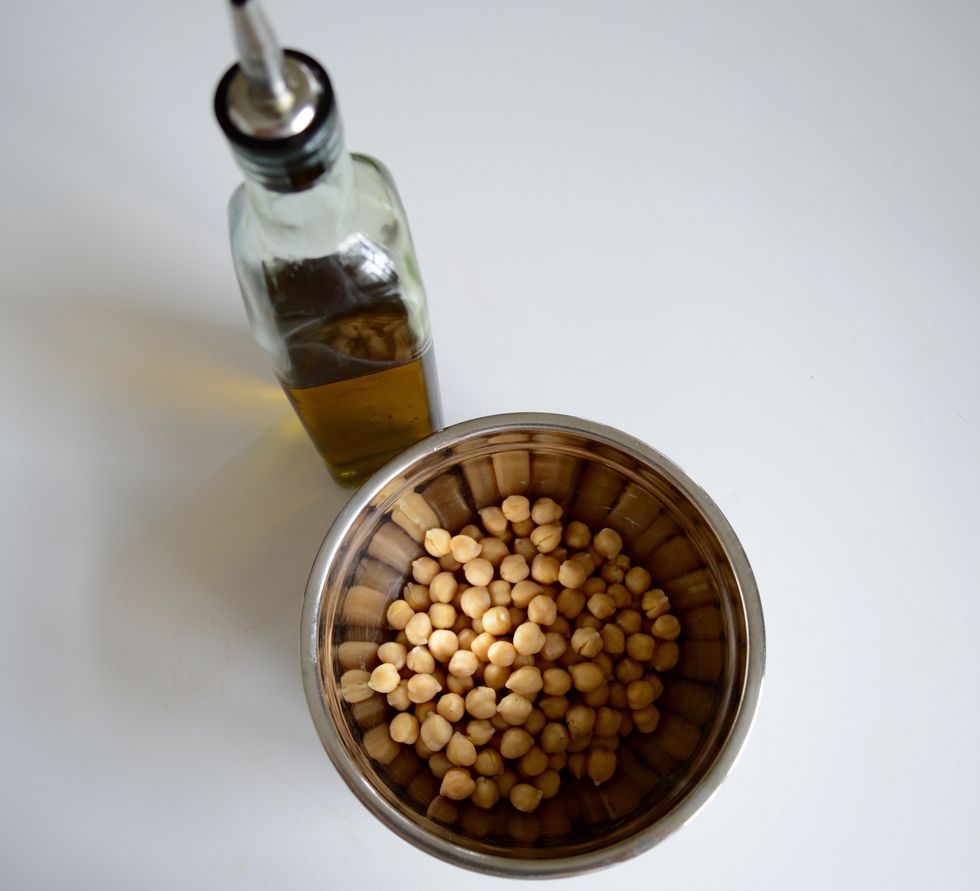 Use just enough oil to coat the beans. You don't want a greasy mess. Its also a good idea to season them at this step. That way noting will burn on the tray.