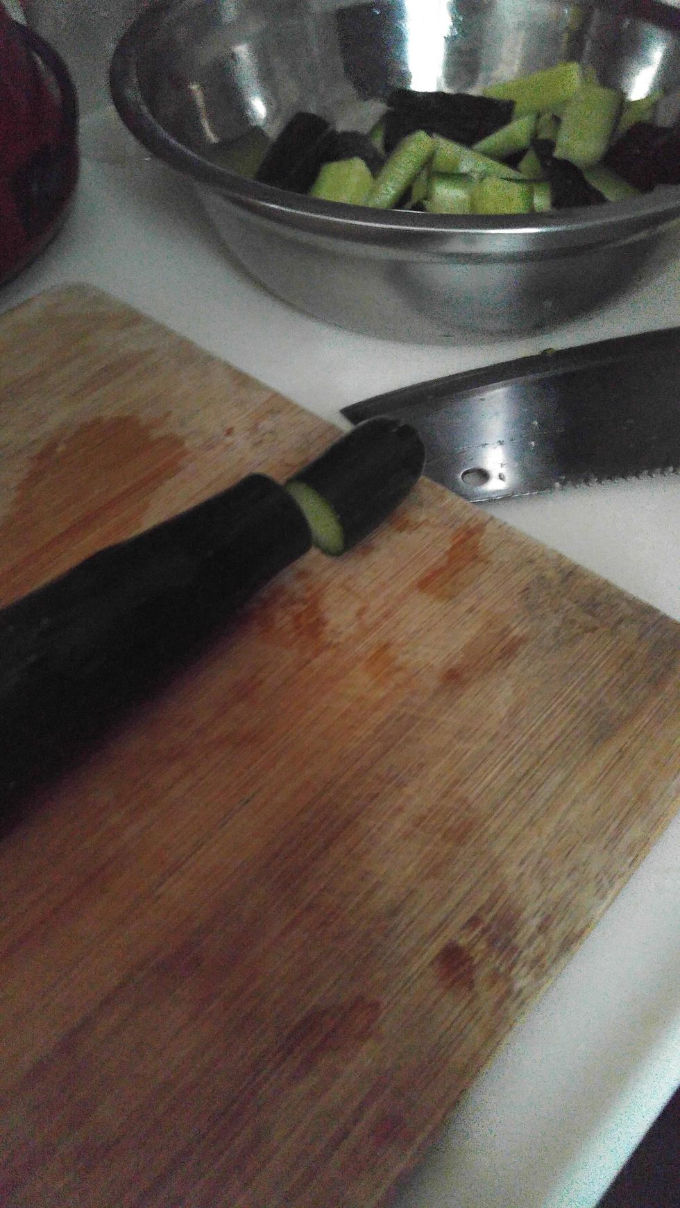 Use knife to cut the cucumber.