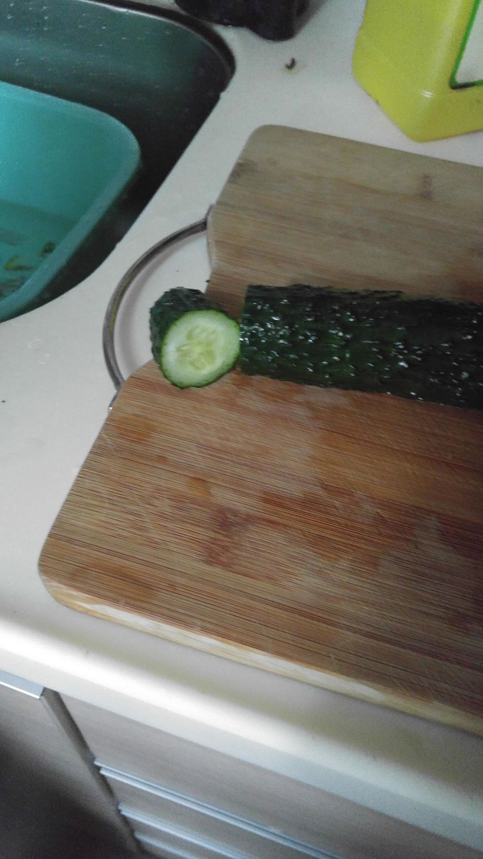 Use knife to cut the cucumber.