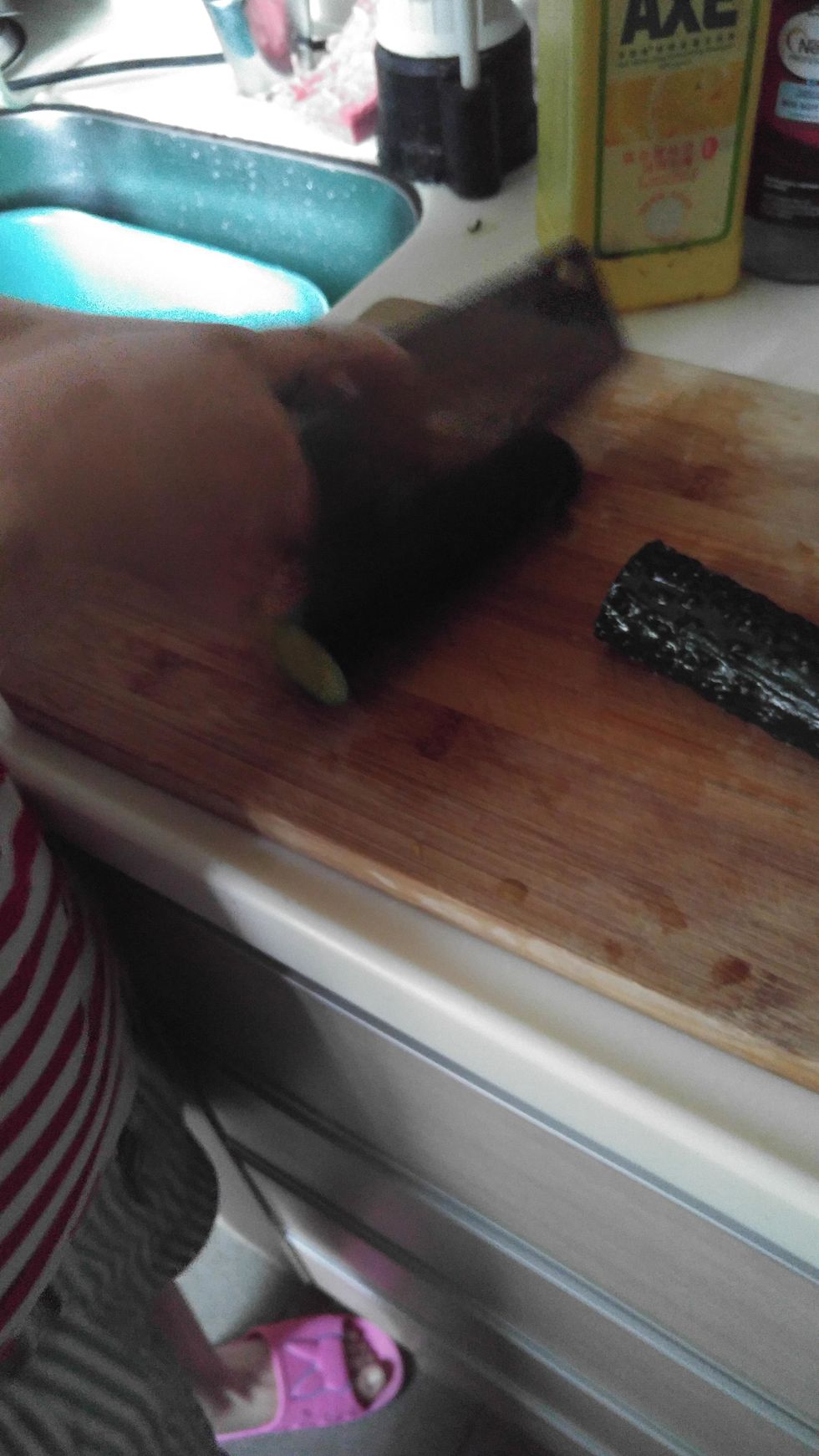 Use knife to cut the cucumber.