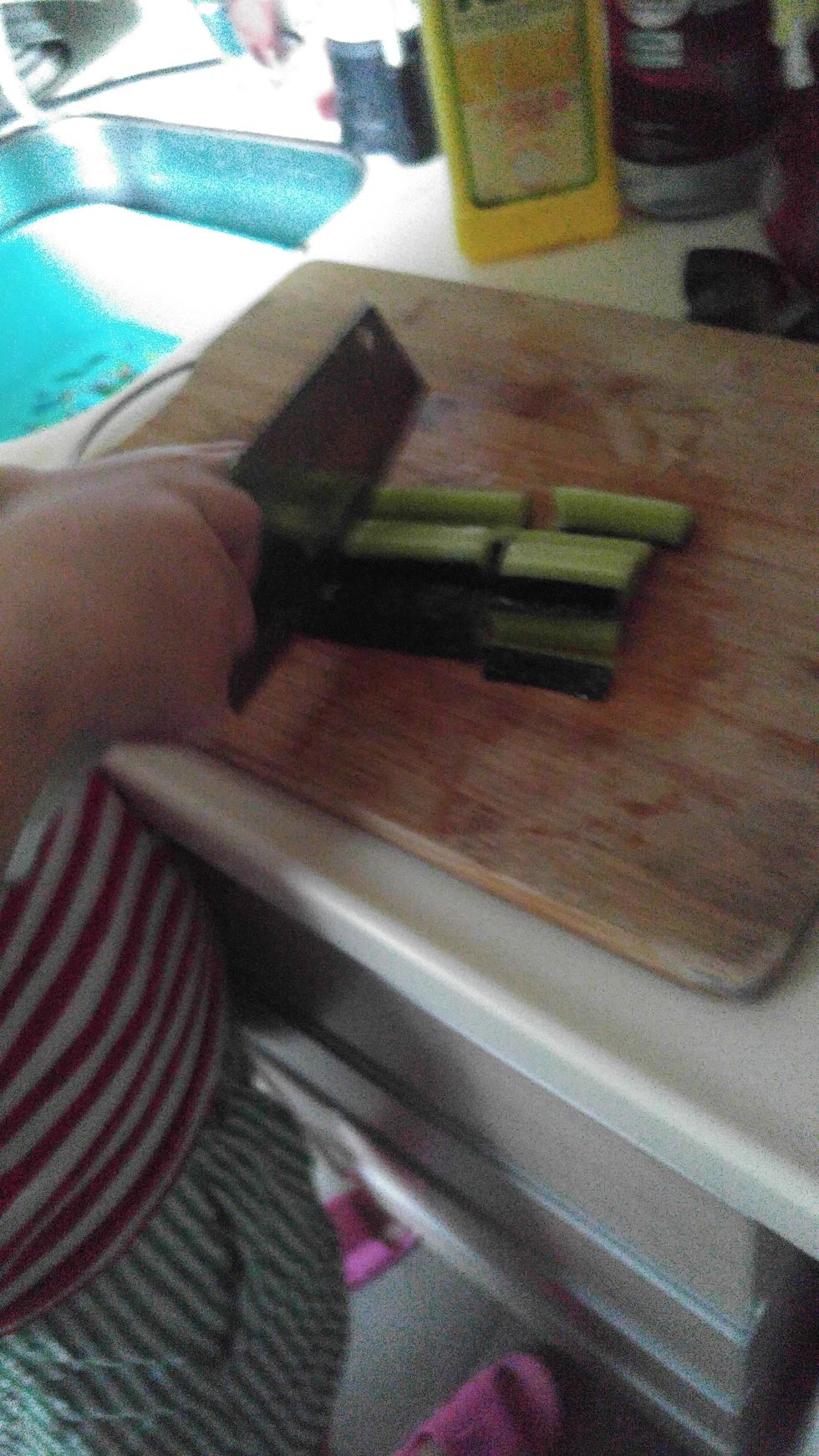 Use knife to cut the cucumber.