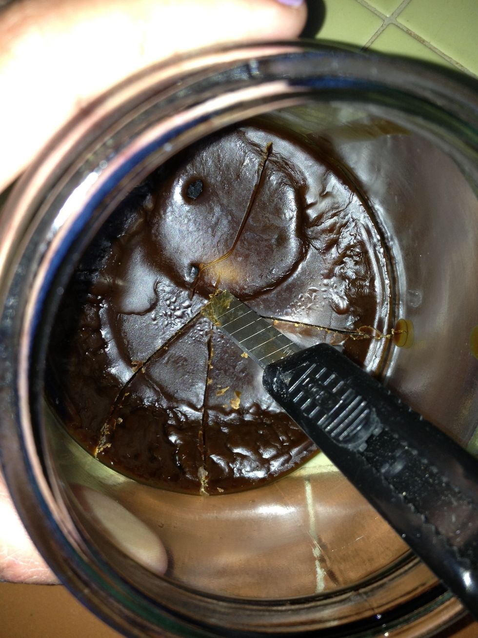 use knife to cut thru wax like you'd cut a pie. make sure you cut all the way to the glass.