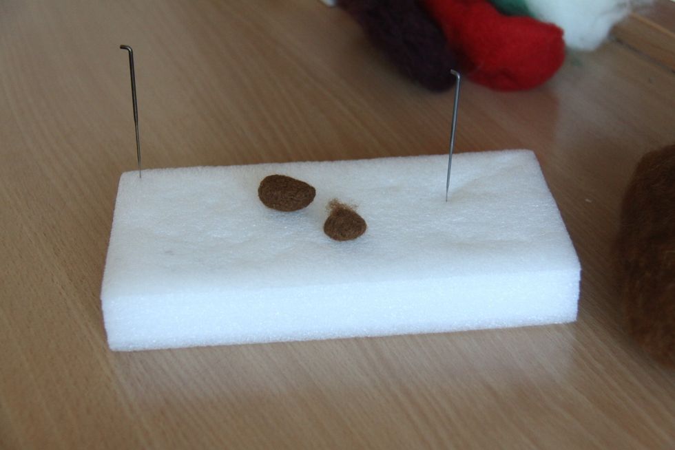 Use less light brown wool than in step 1, form a ball and punch one side to make it flat, leave a little bit of wool untouched on top so you can use it to attach this part to the head.