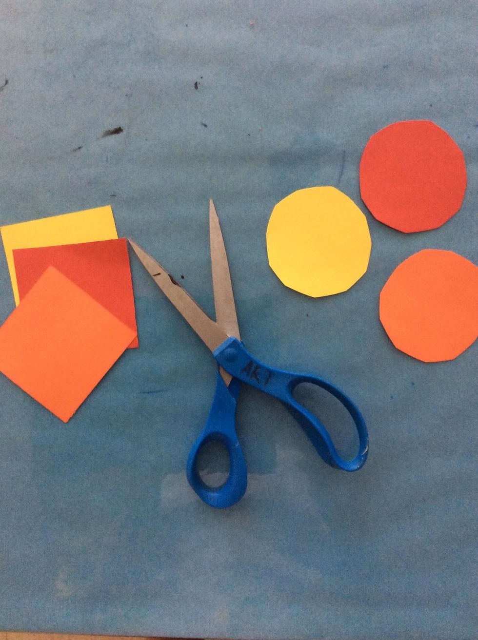 Use marigold-colored papers and cut circles.