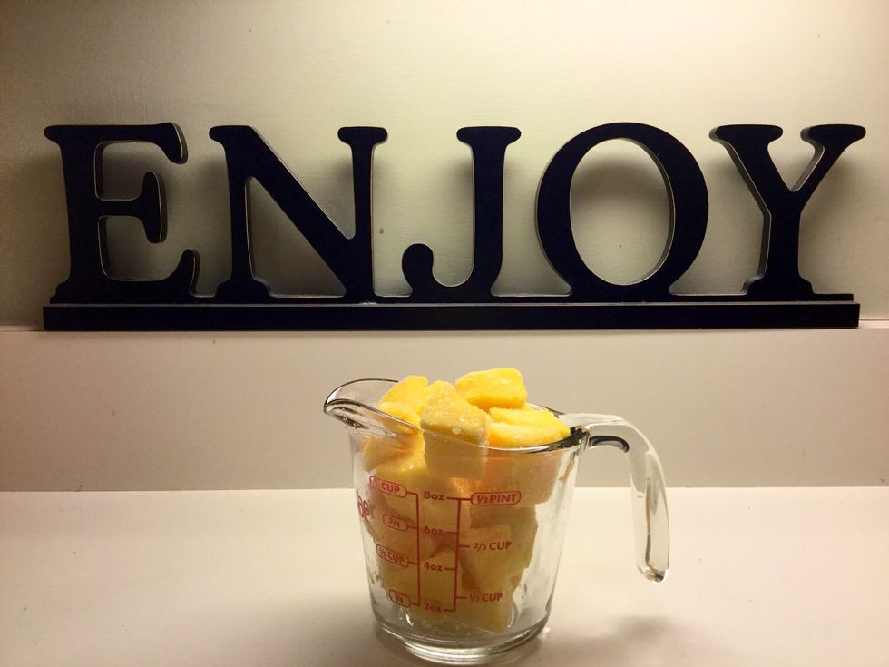 Use measuring cup to measure one cup of frozen mango