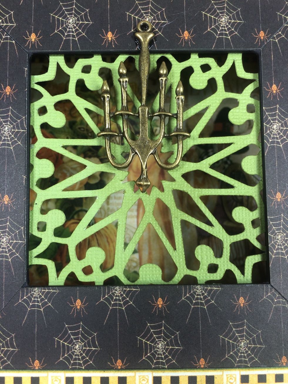 Use metal glue to adhere a spooky charm to the box front. I found this chandelier online, but check your local craft store first.