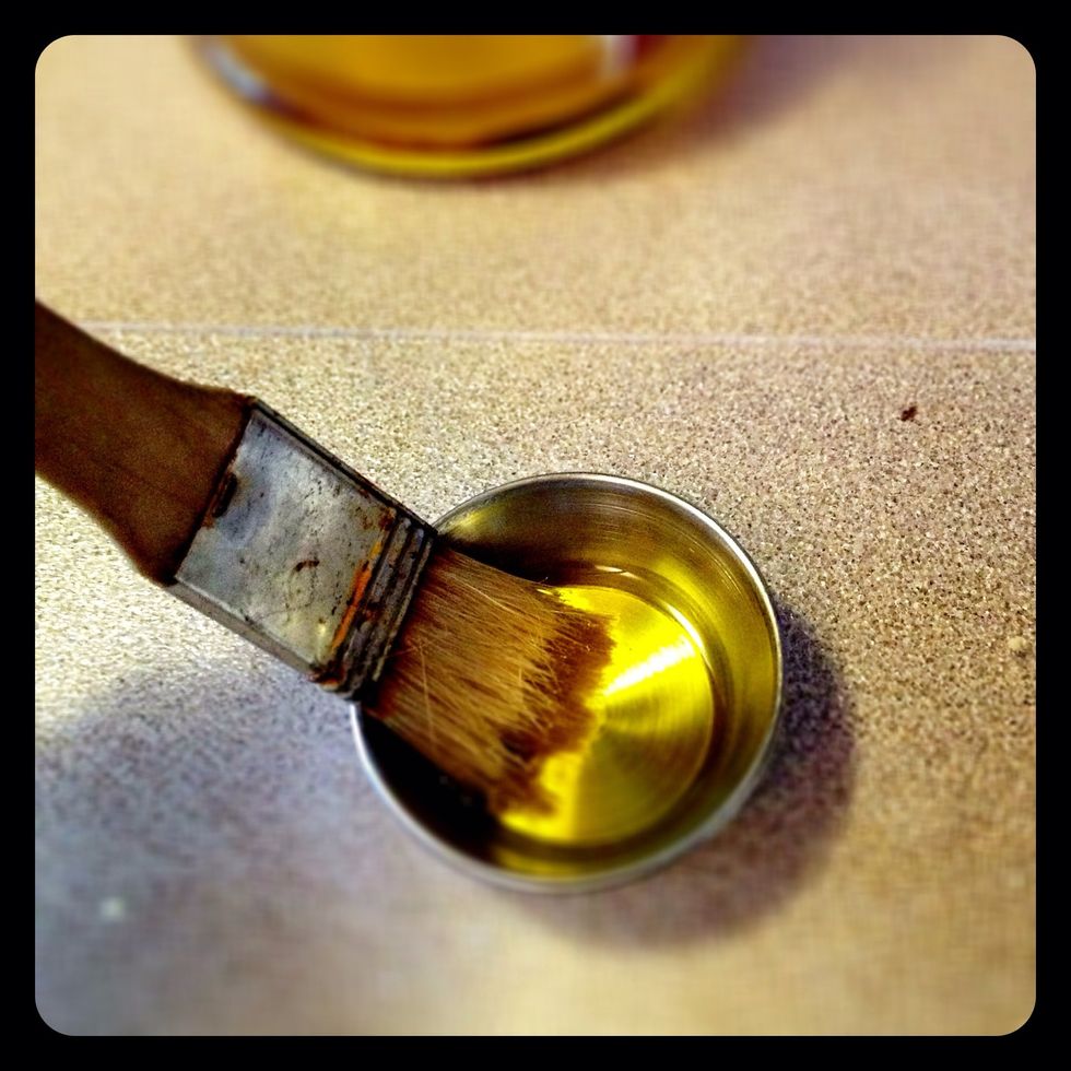 Use olive oil and a pastry brush.