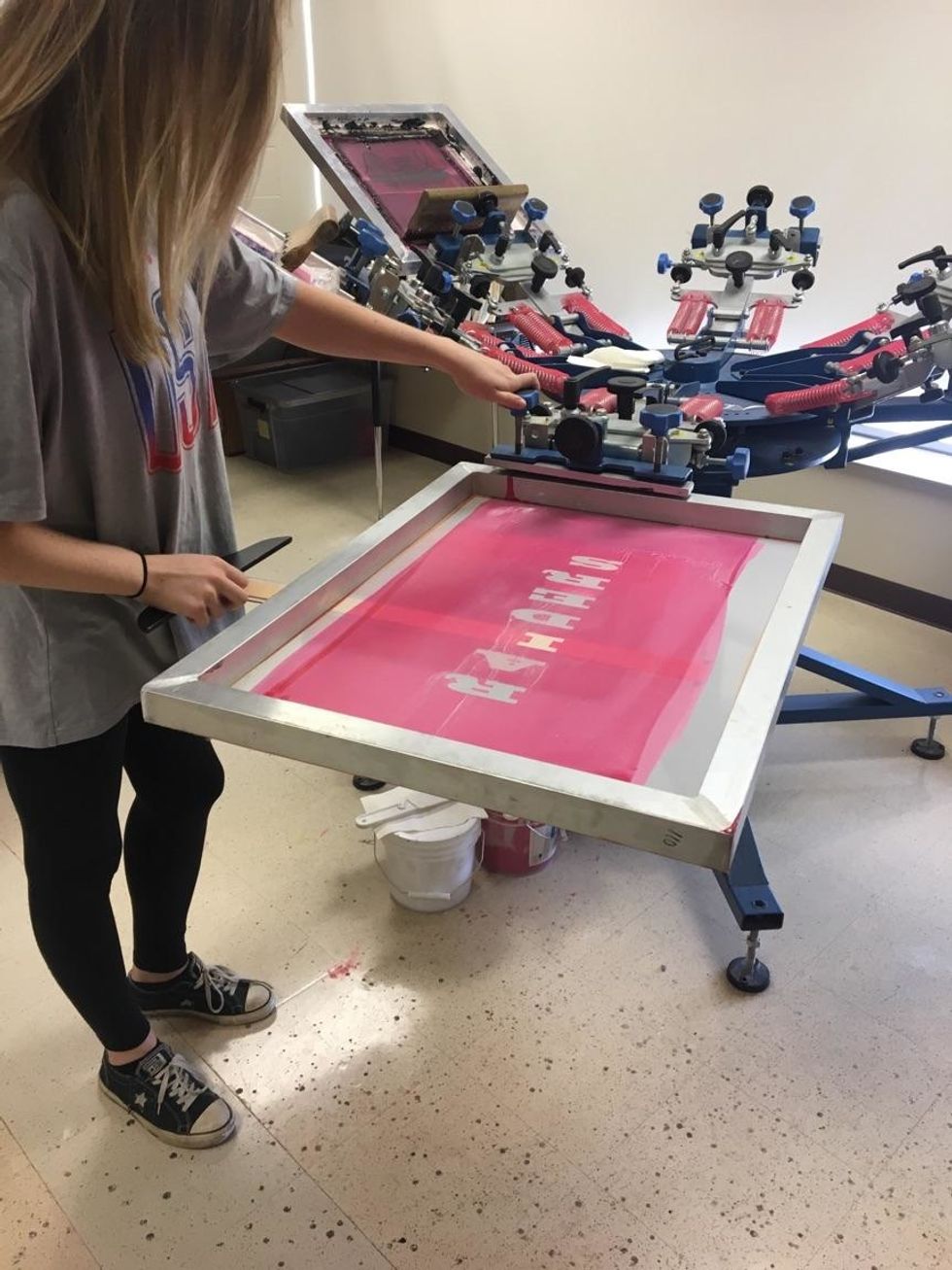 Use one or two t-squares to line up the screen to the palette. Once it is centered, tighten the screws to secure the screen in place.